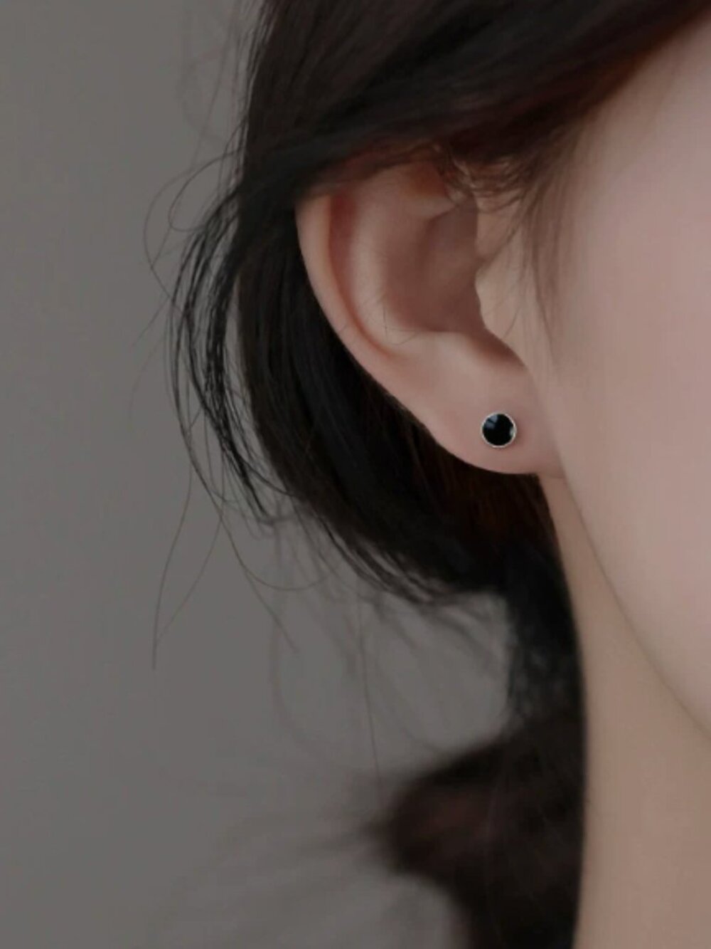 Black resin-coated round screw-back stud earrings